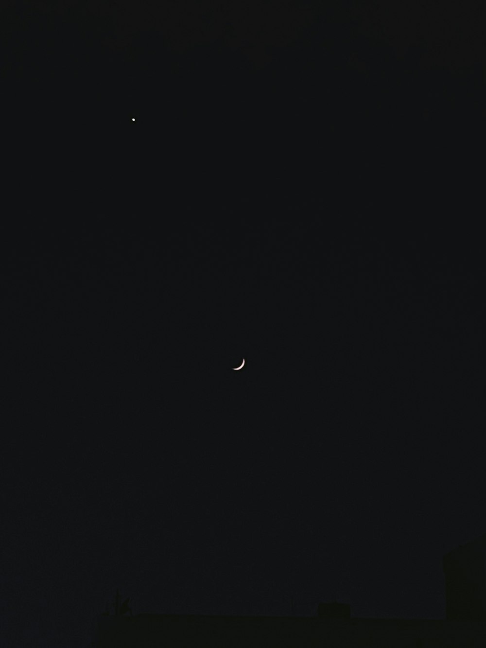 a view of the moon and a distant object in the sky