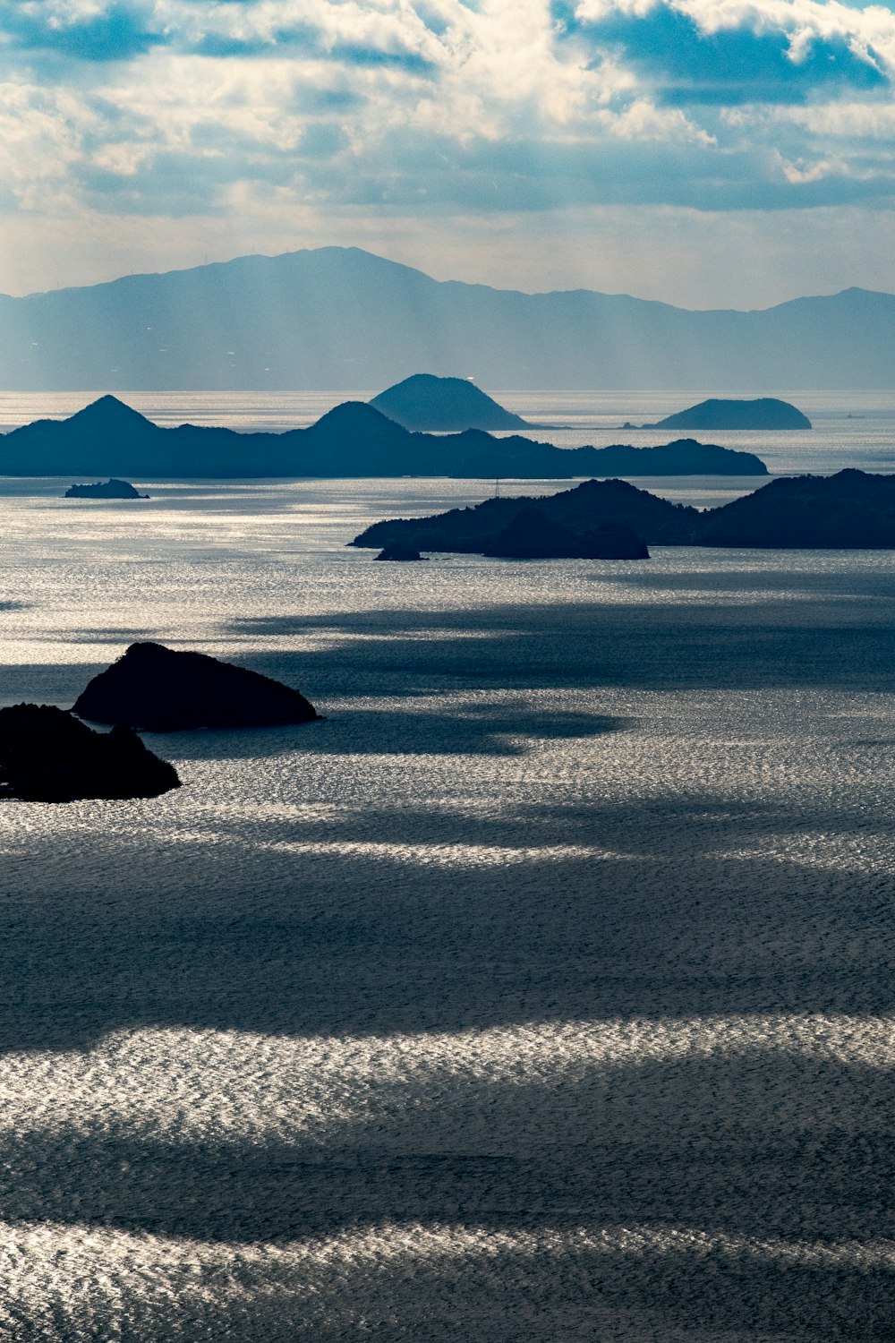 a body of water with a mountain in the background