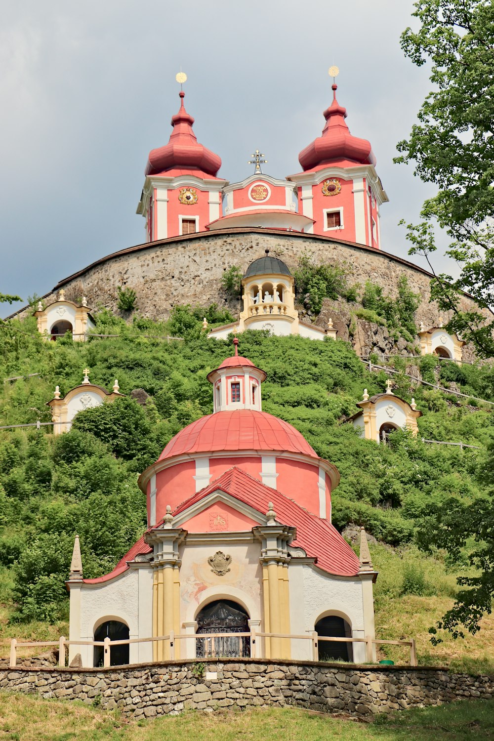 a church on a hill with a steeple in the background