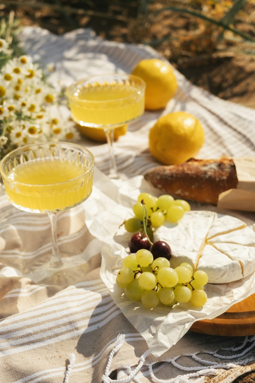 a table topped with a plate of food and glasses of wine