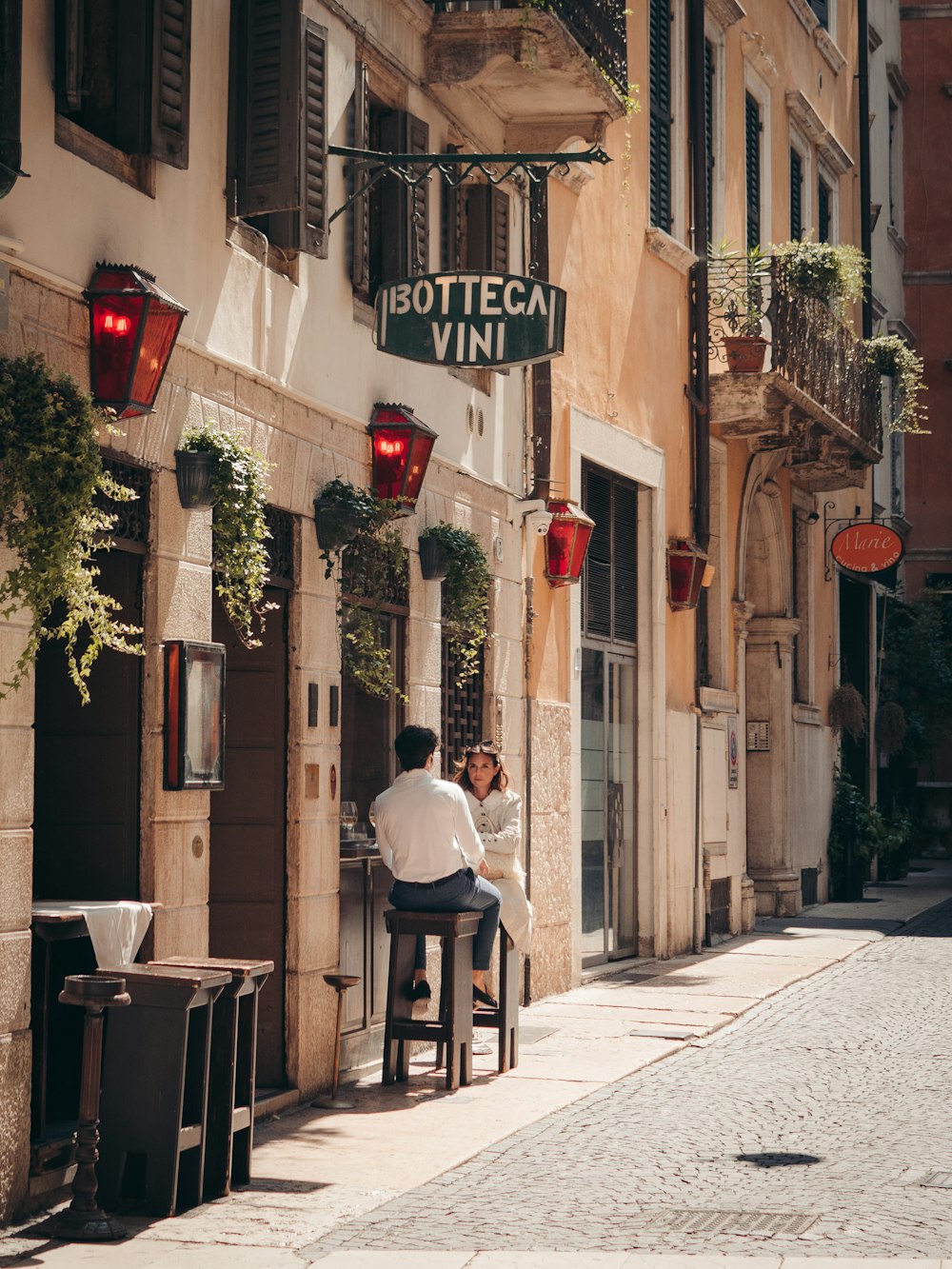 a man sitting at a table in front of a restaurant