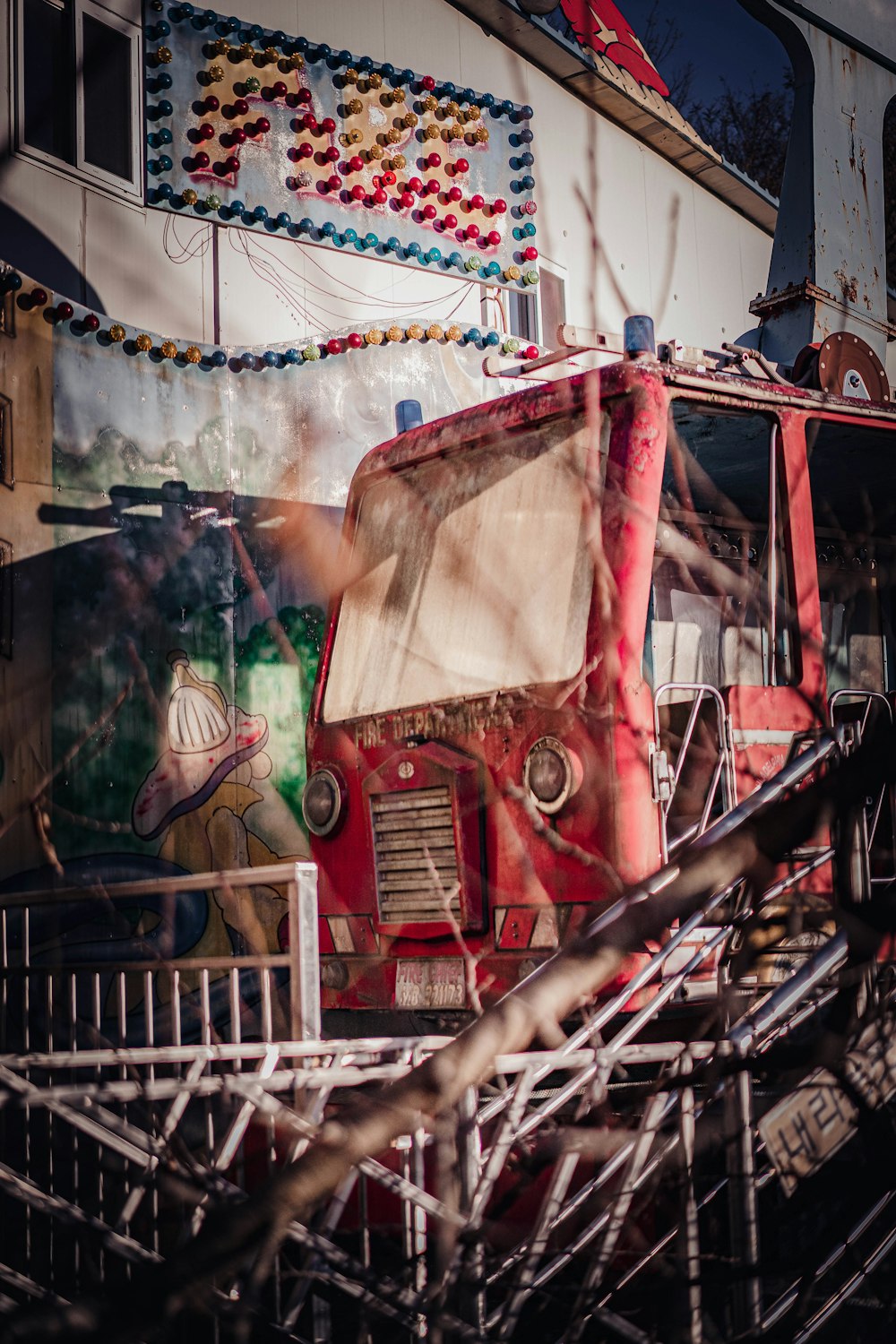 a red truck parked in front of a carnival ride