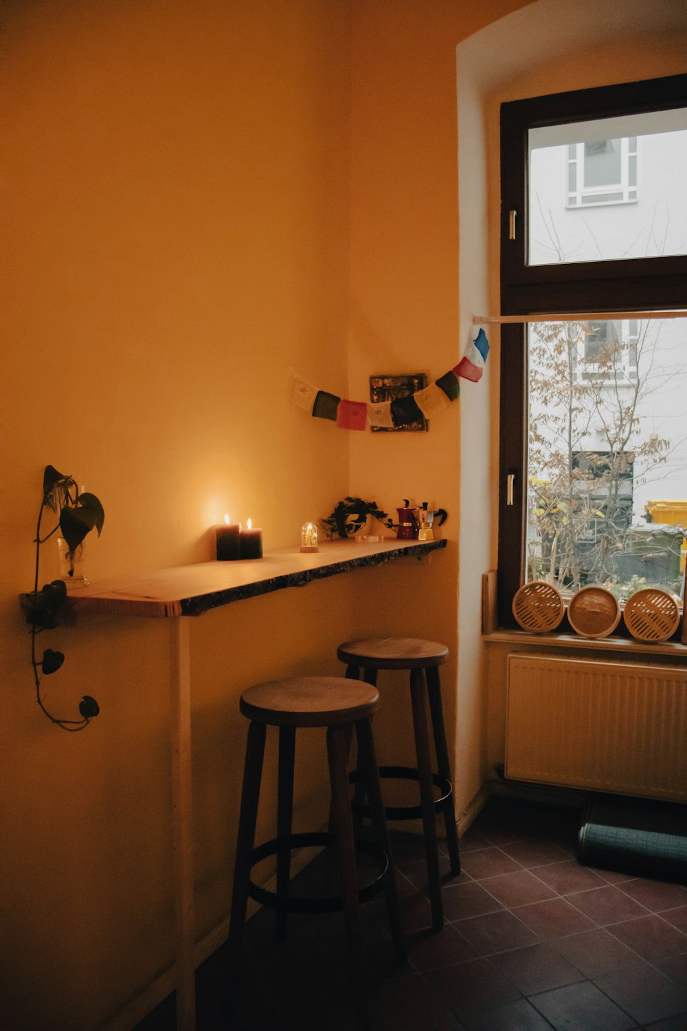 two stools in front of a window in a room