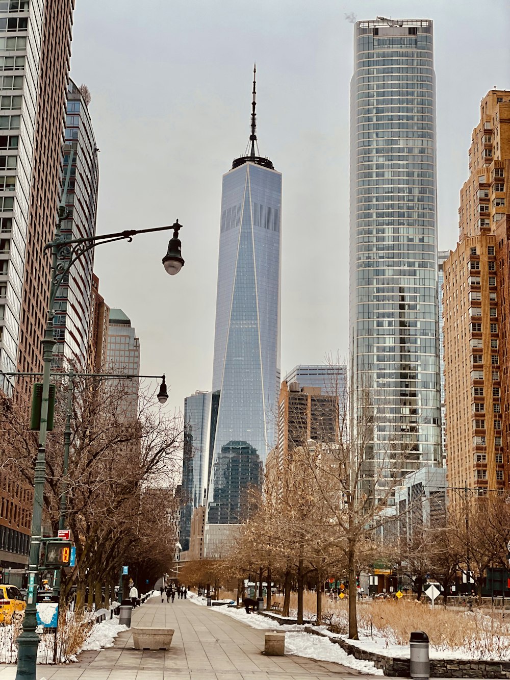 a city street with tall buildings in the background