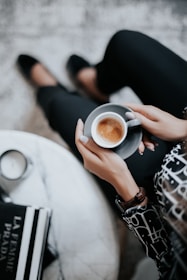 A cozy café scene with a model sipping coffee, dressed in a chicavenuee outfit that blends comfort and style.