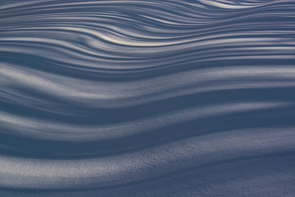 a snowboarder is riding down a snow covered slope