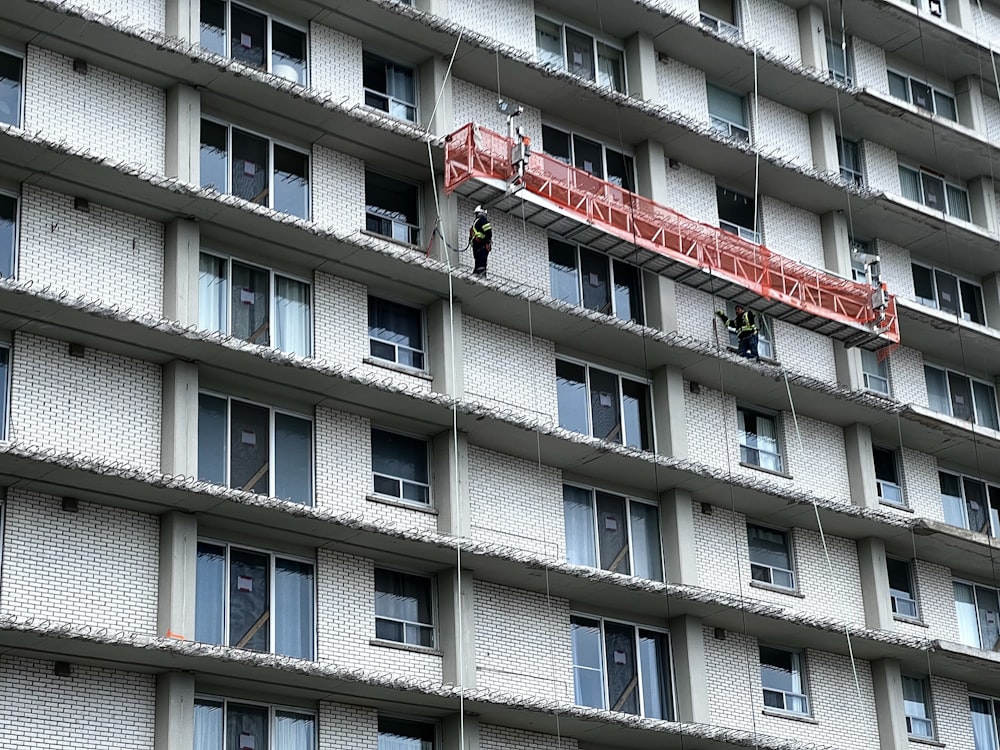 a man on a ladder working on a building