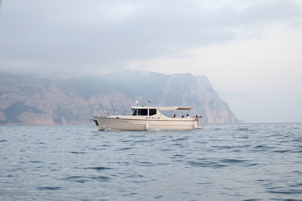 a white boat in the middle of a body of water