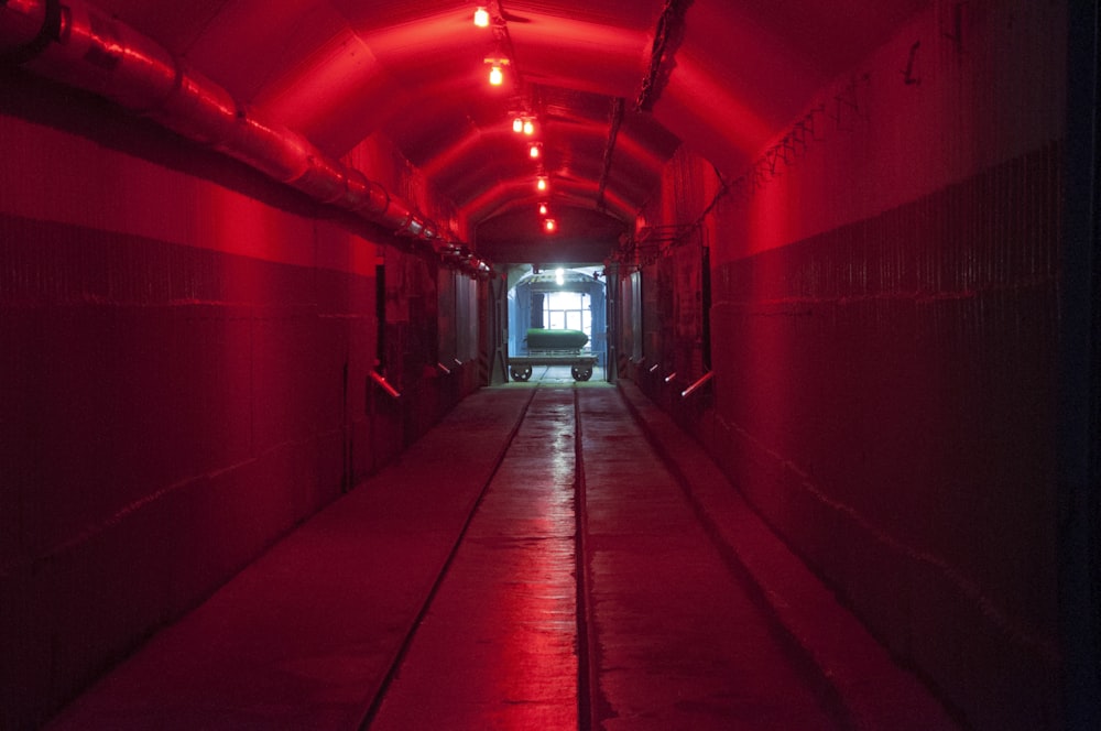 a long tunnel with a red light at the end