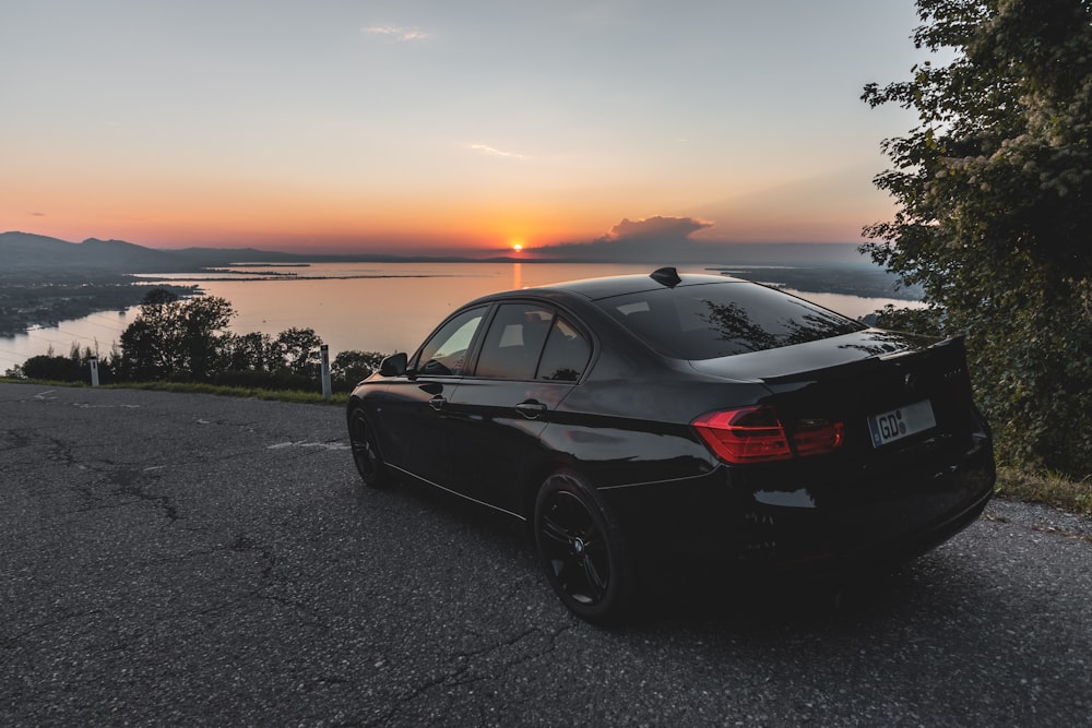 a black car parked on the side of a road