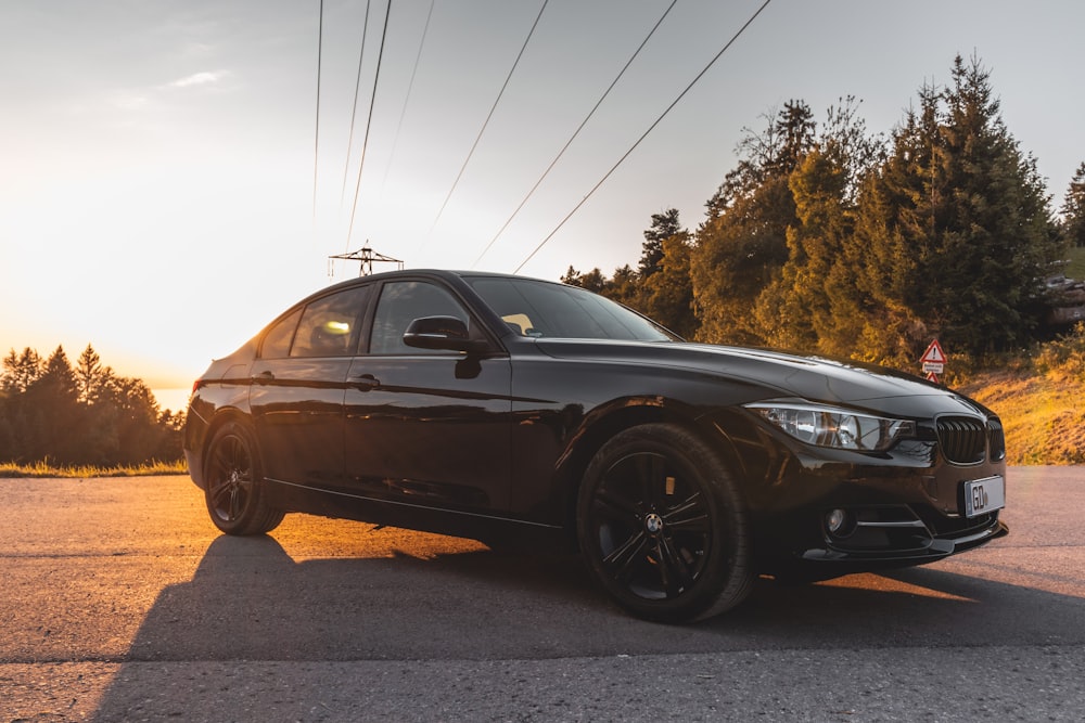 a black car parked on the side of the road