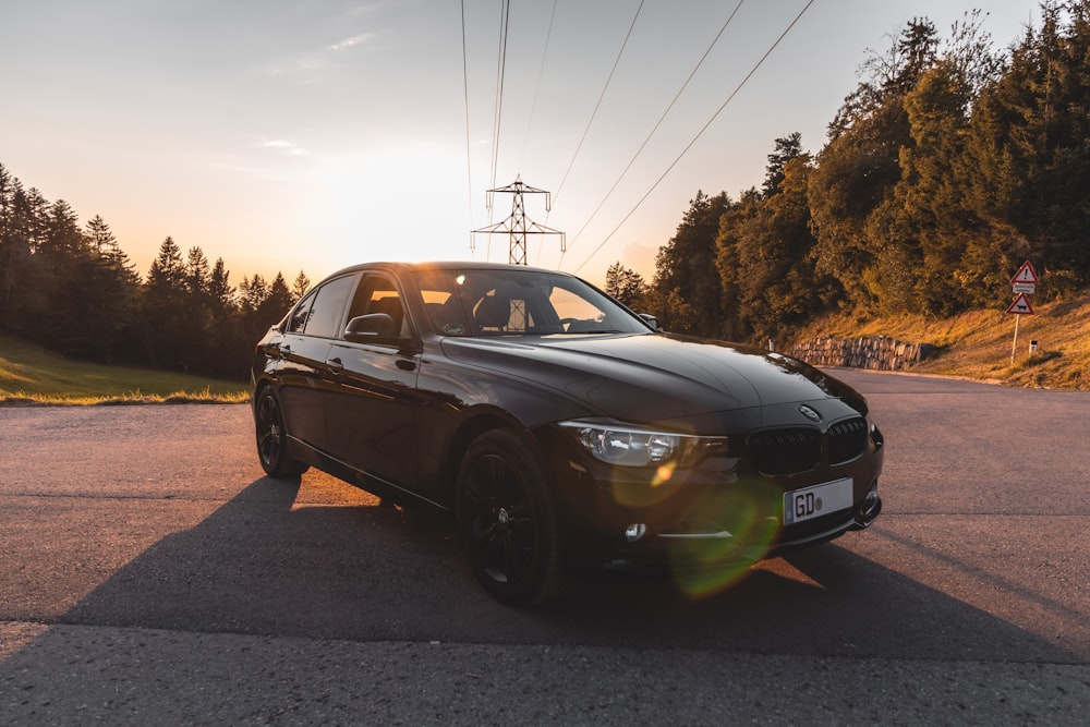 a black car parked on the side of a road