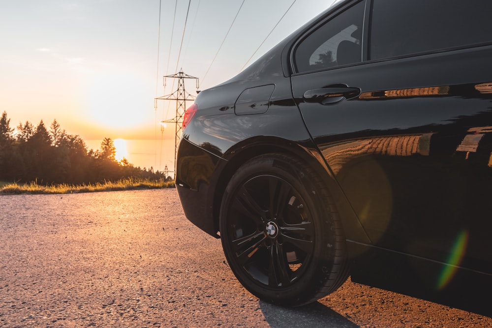 a black car parked on the side of the road