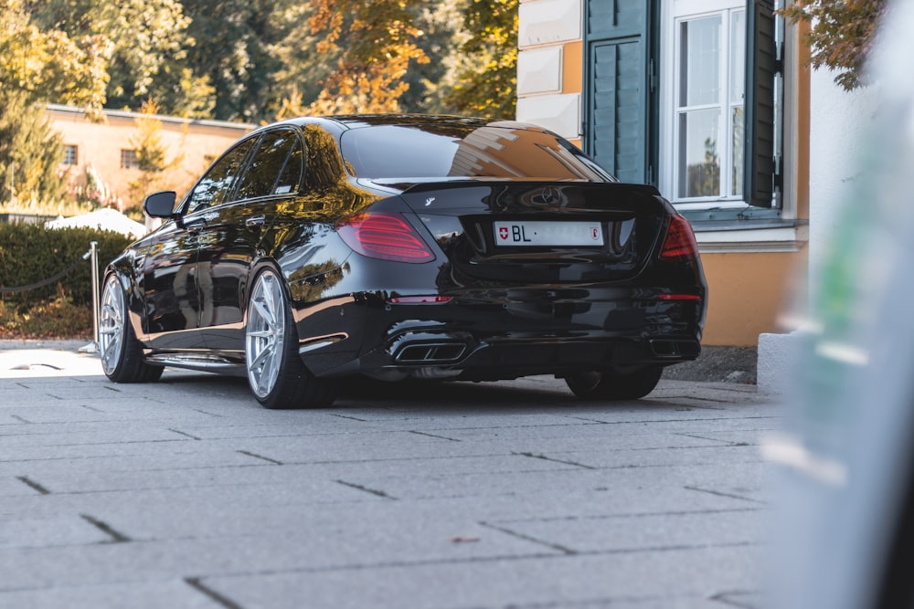 a black car parked in front of a building