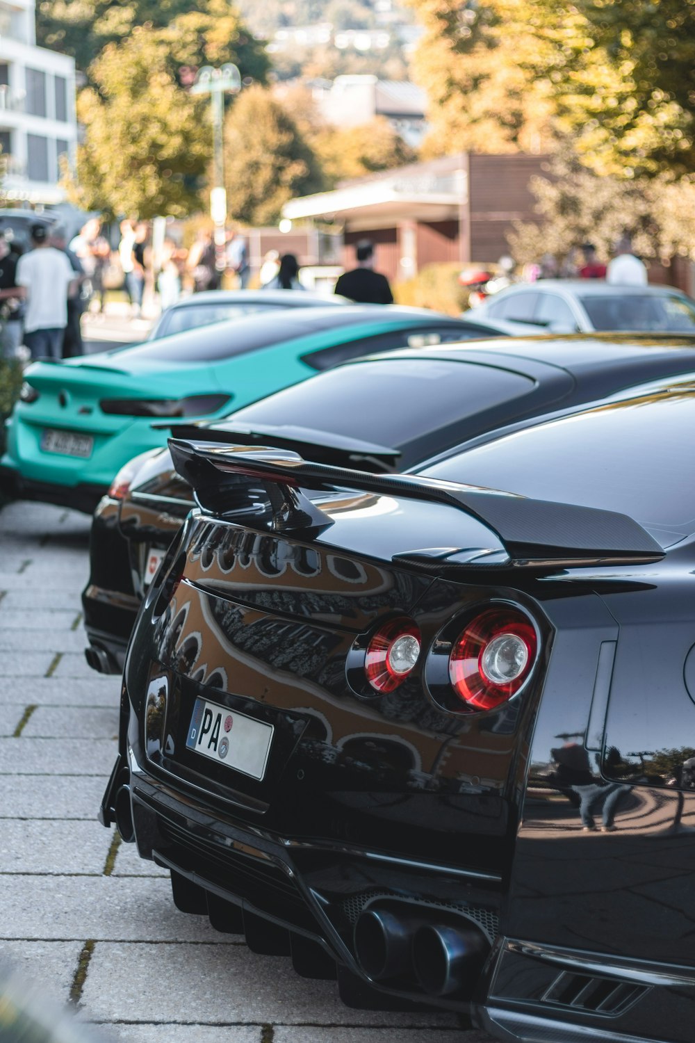 a row of black sports cars parked next to each other