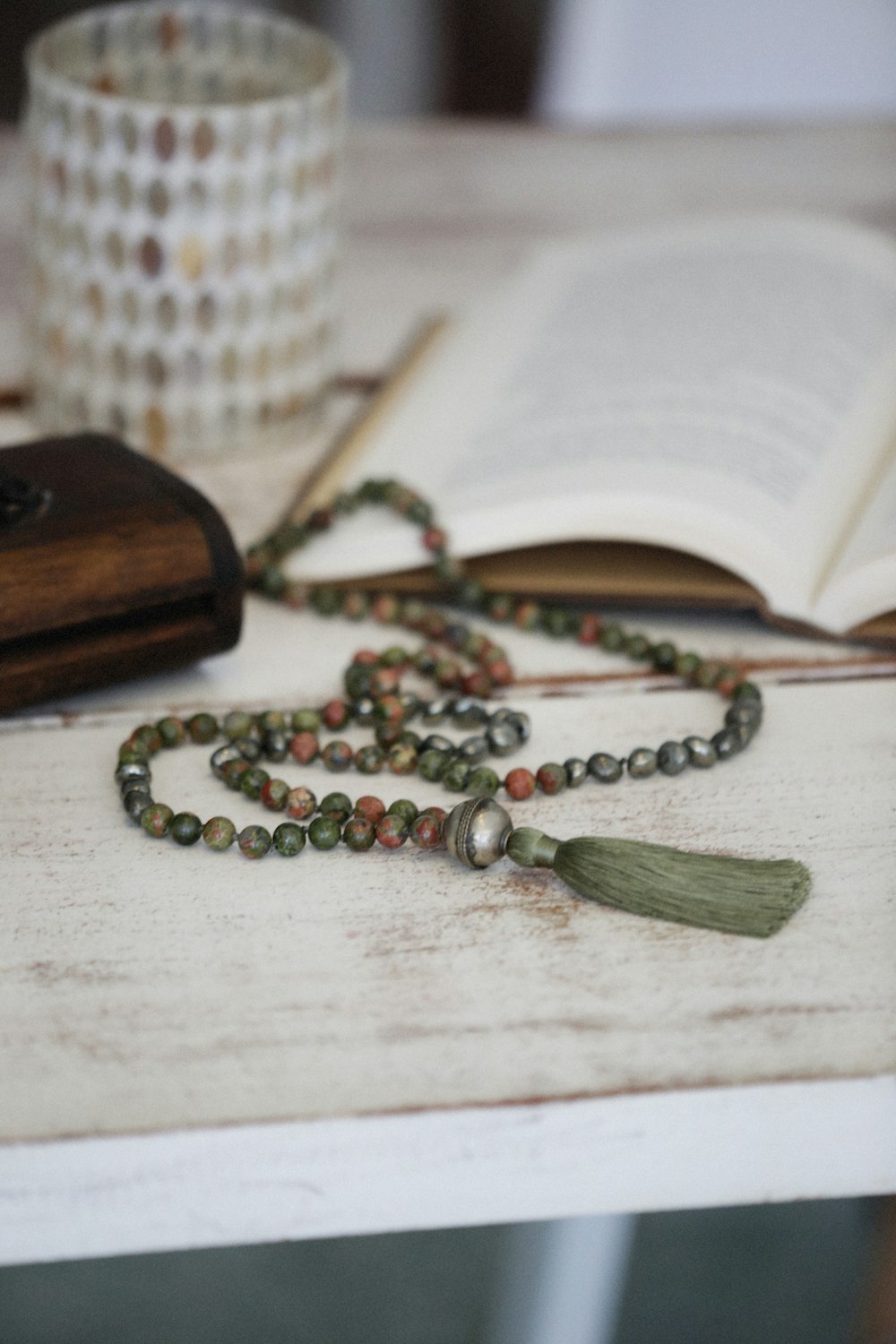 a rosary and a book on a table