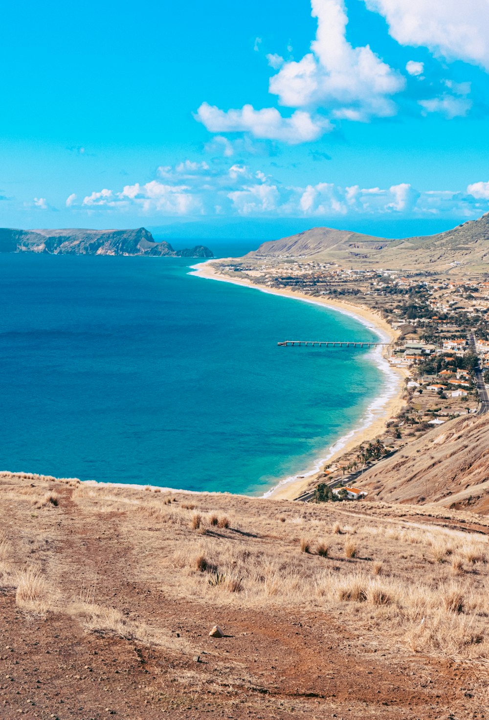 a scenic view of a beach and a body of water