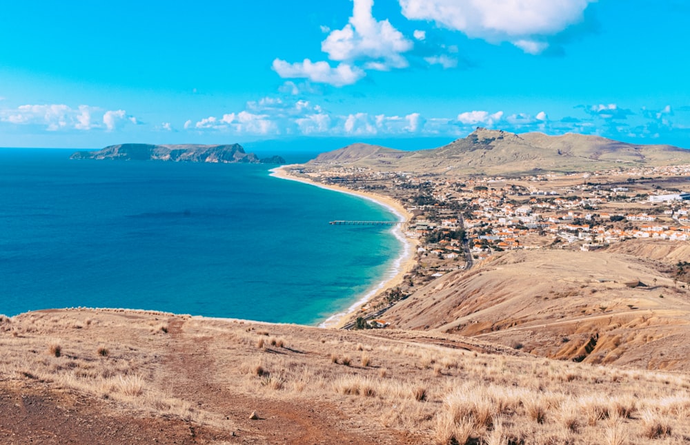 a scenic view of a town and the ocean