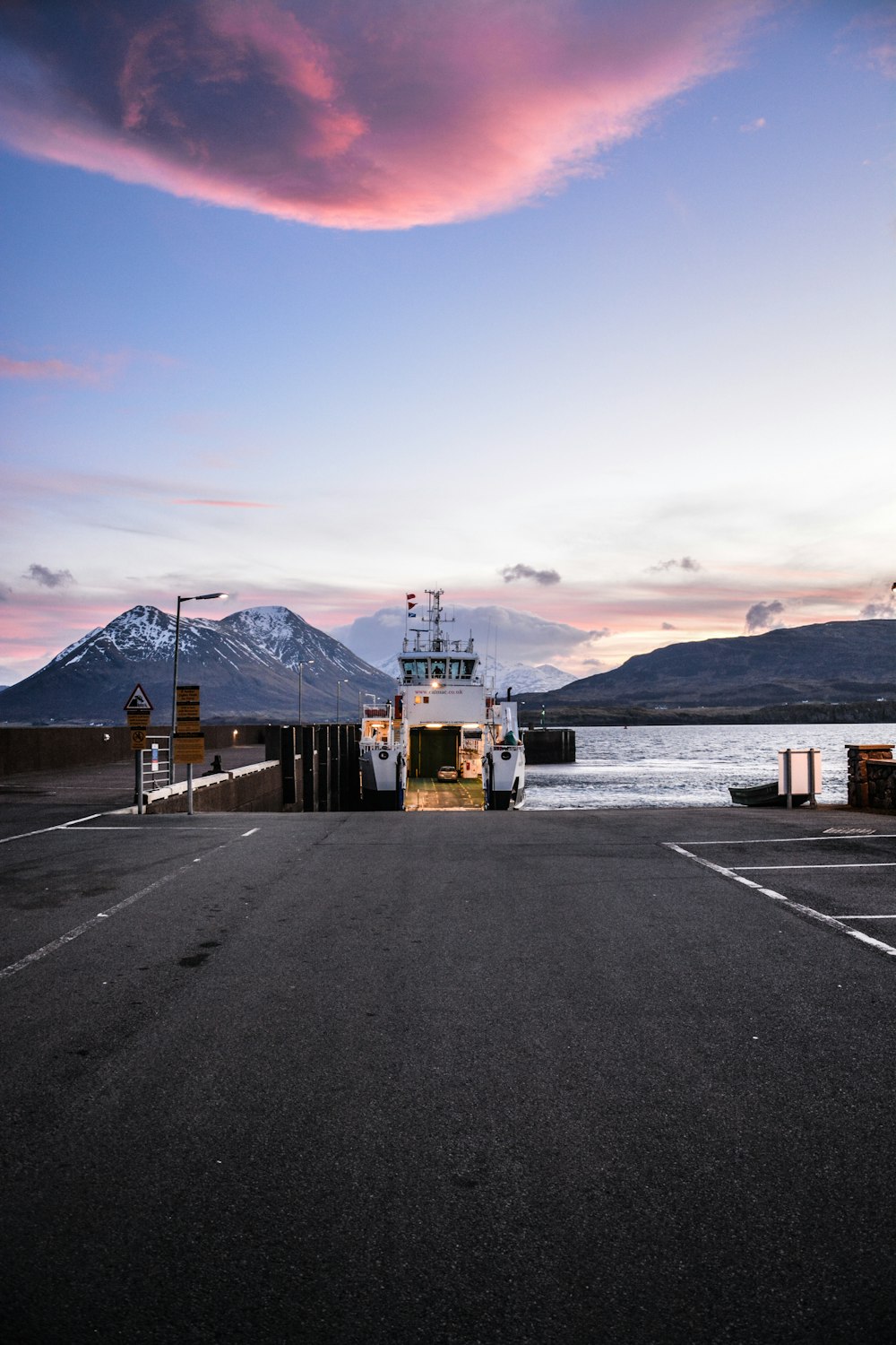 a boat is docked in a parking lot