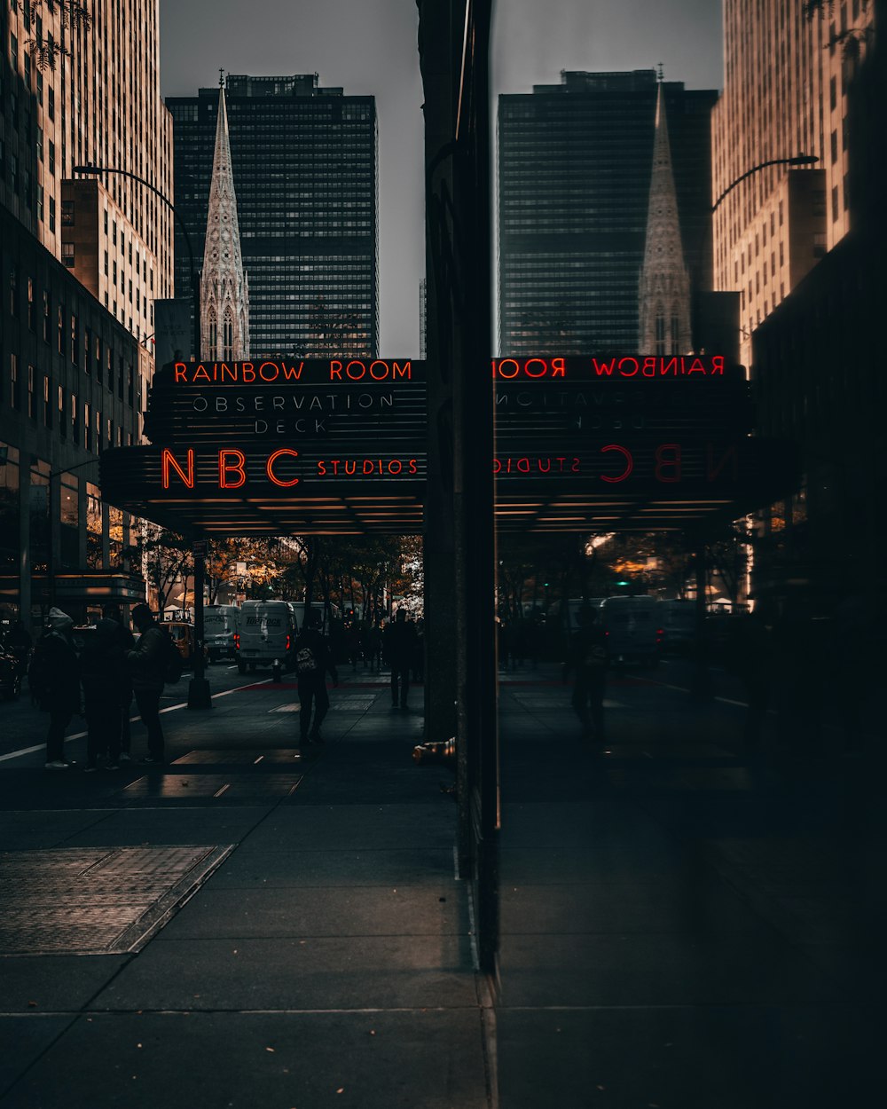 a city street at night with tall buildings