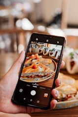 a person taking a picture of food on their phone