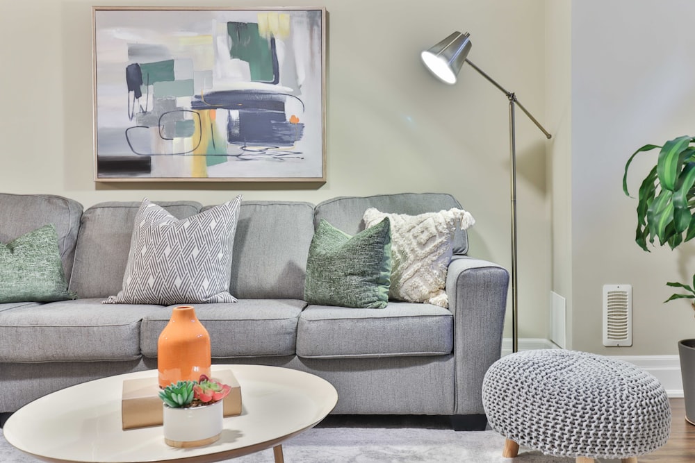 a living room filled with furniture and a painting on the wall