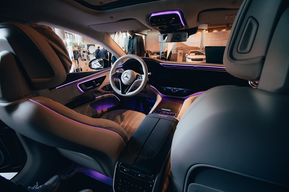 the interior of a car with a steering wheel and dashboard