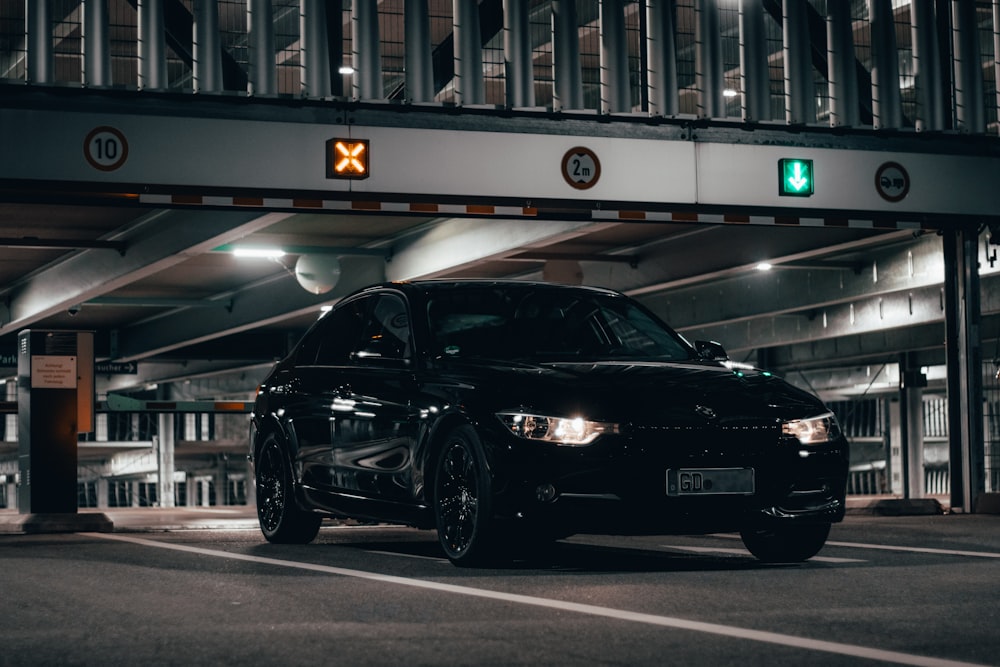 a black car parked in a parking garage