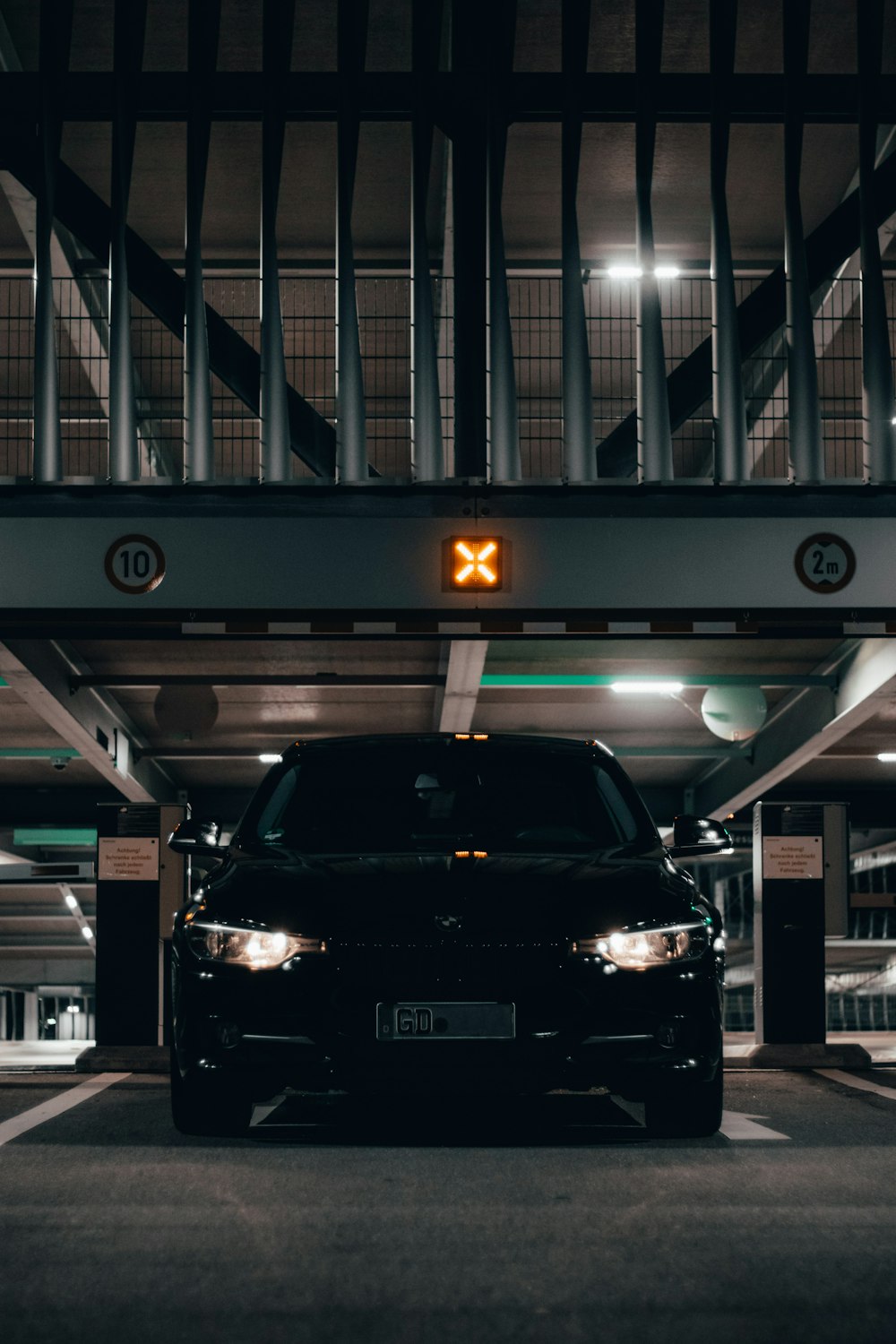 a black car parked in a parking garage