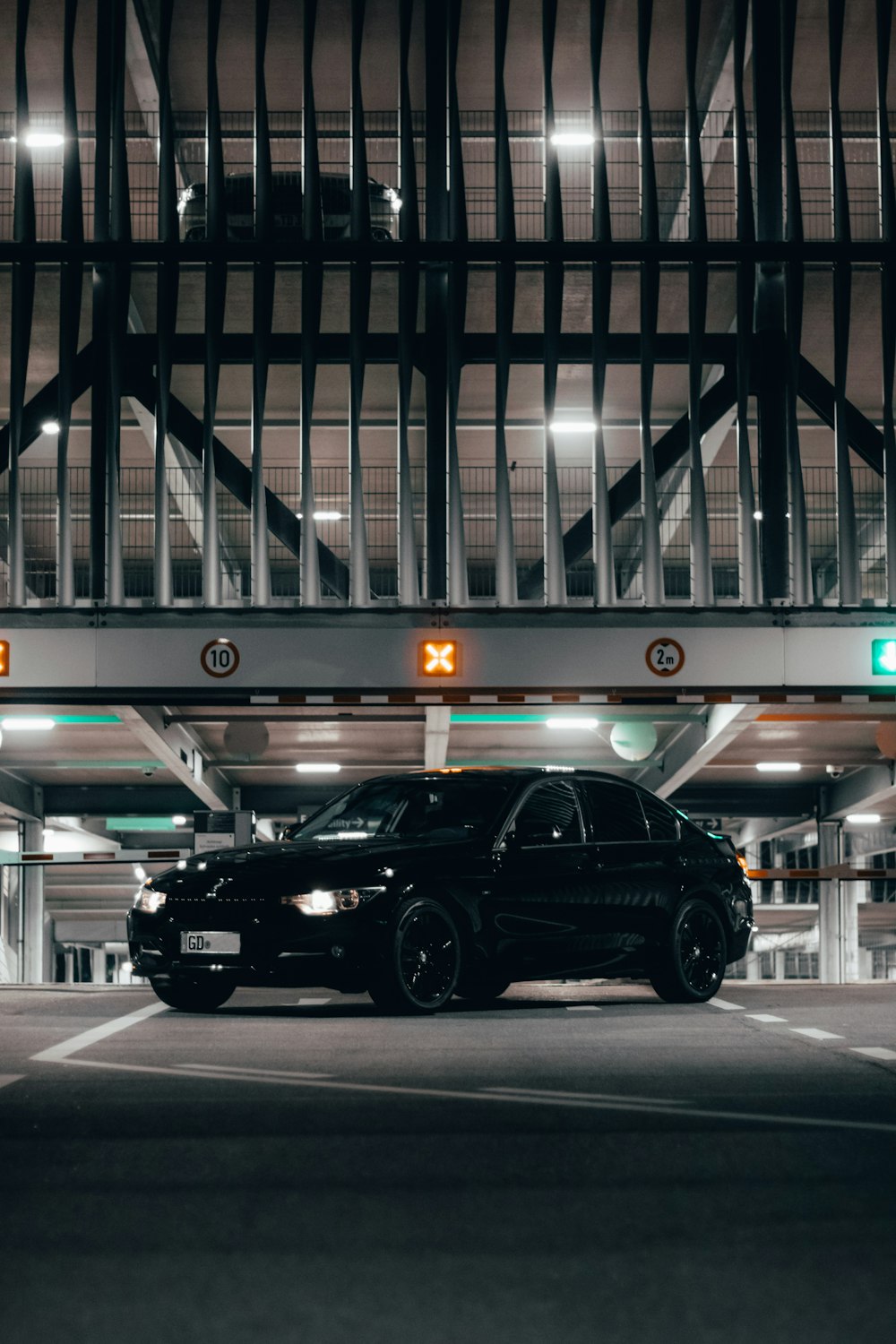 a black car parked in a parking garage