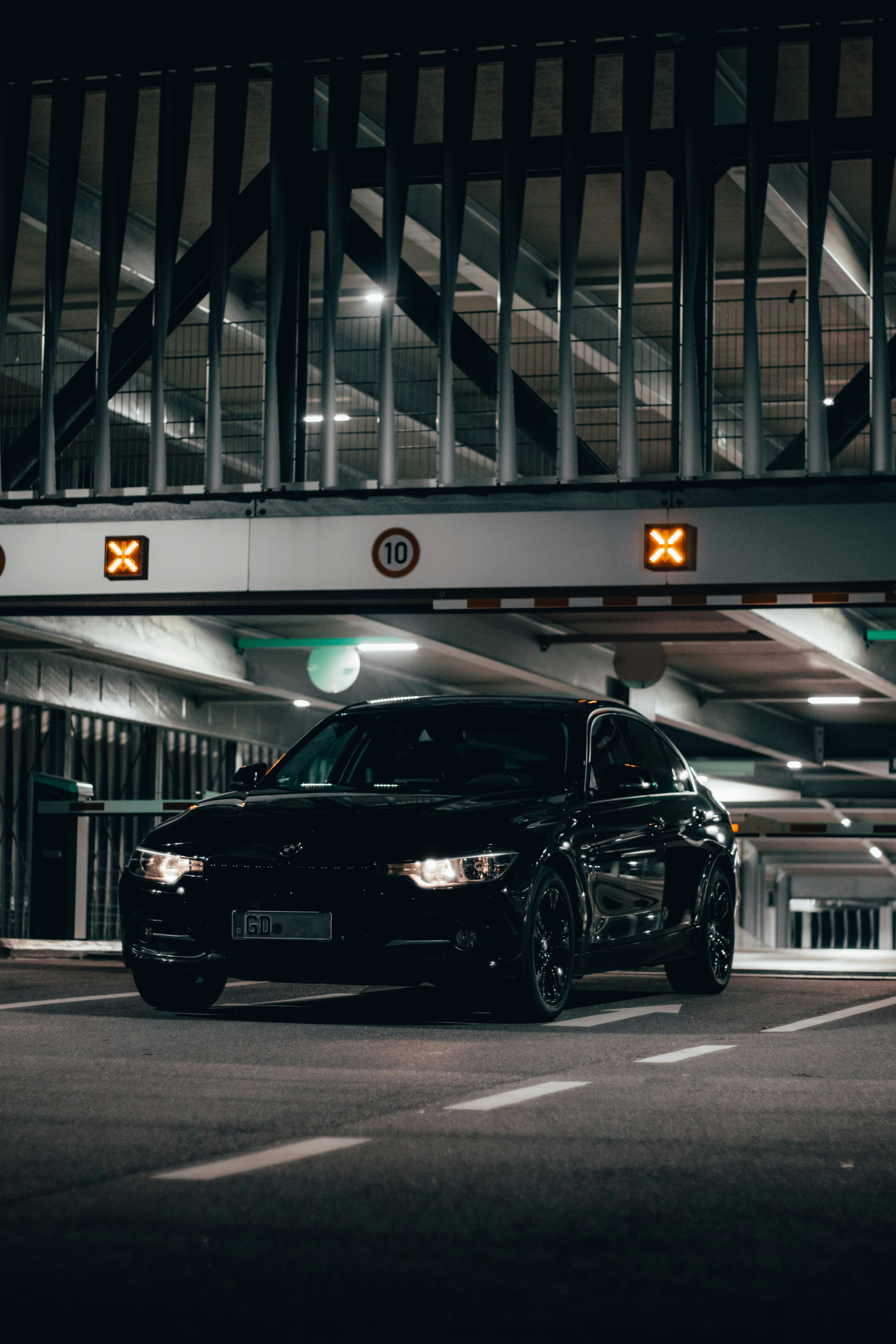 a black car parked in a parking garage