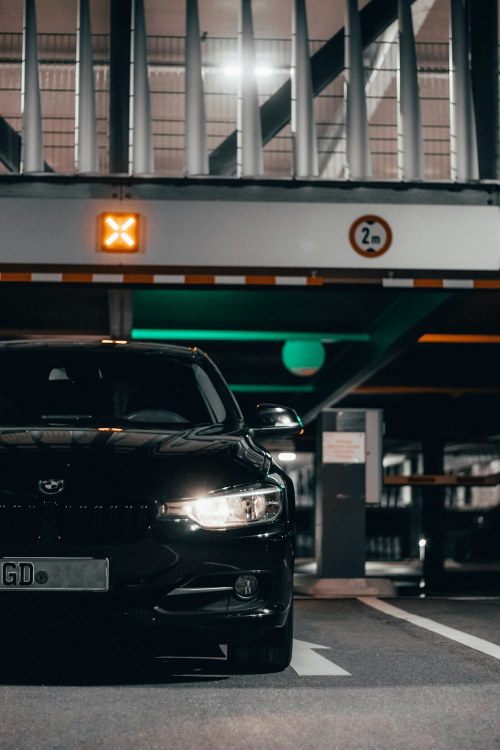 a black car parked in a parking garage