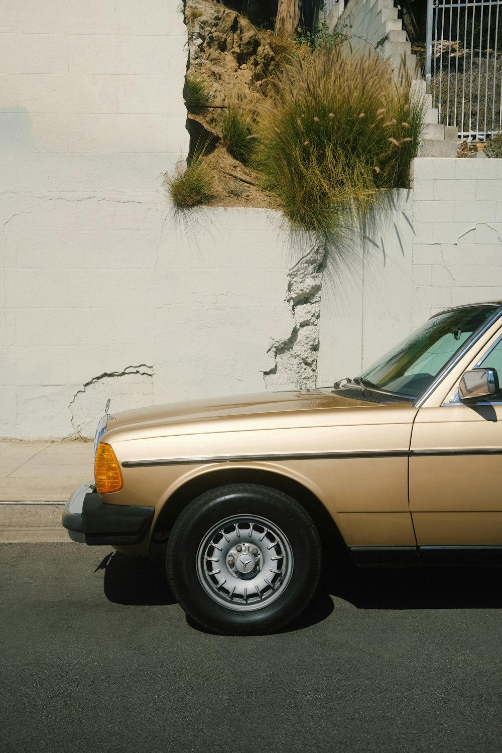 a gold car parked in front of a building