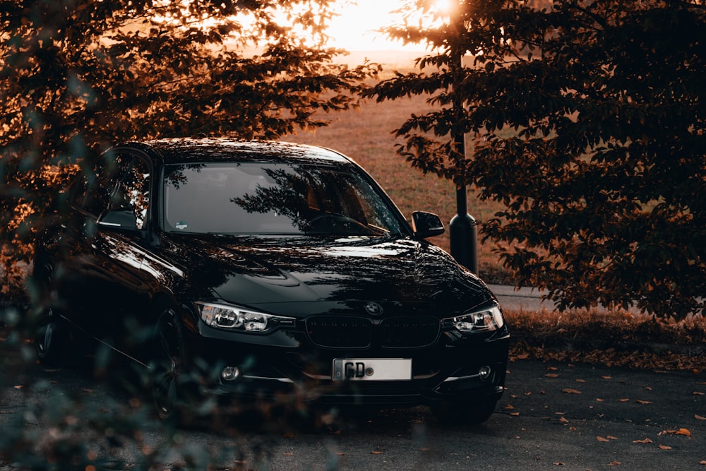 a black car parked on the side of the road