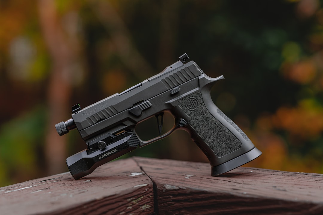 a close up of a gun on a wooden surface