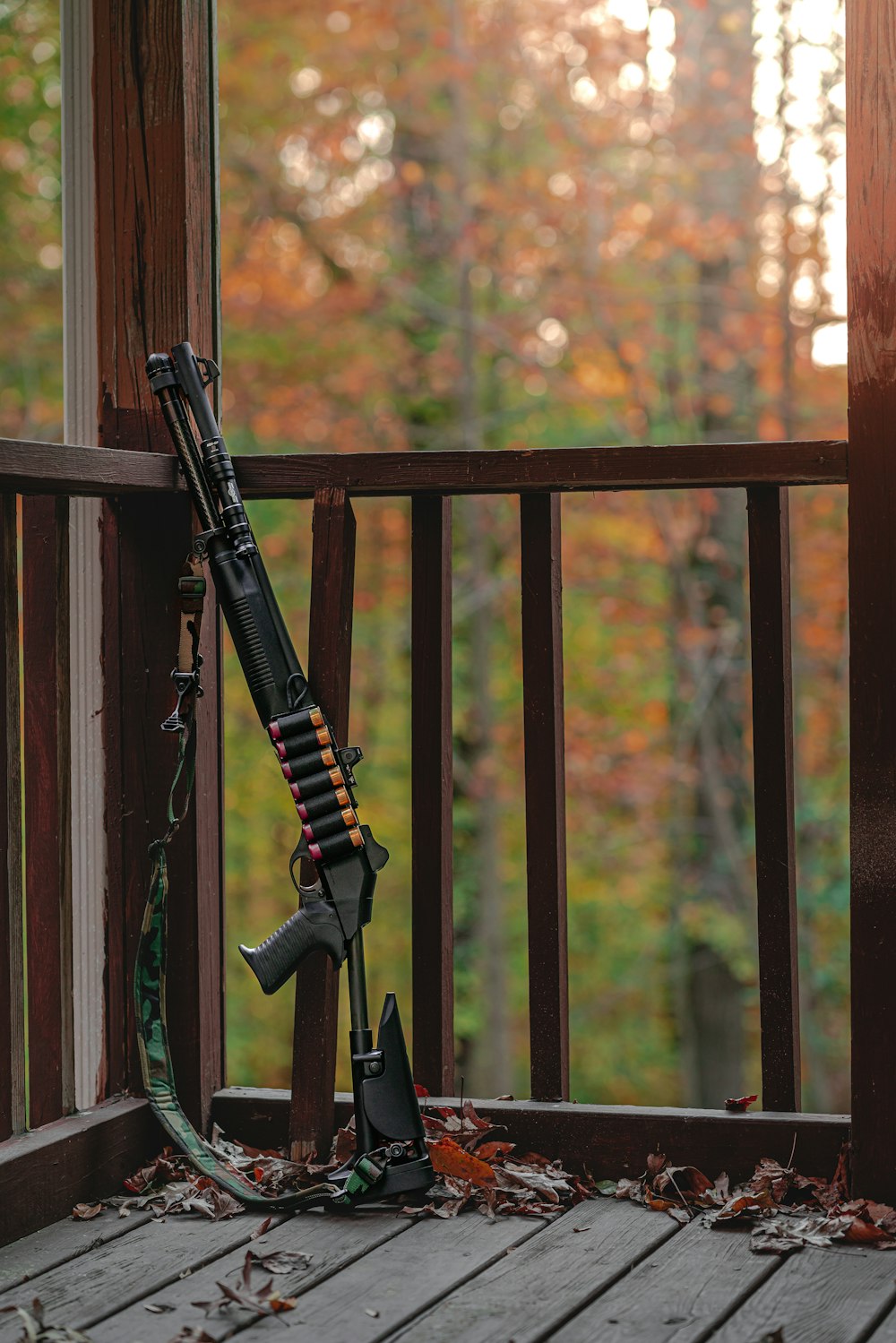 a rifle on the porch of a cabin