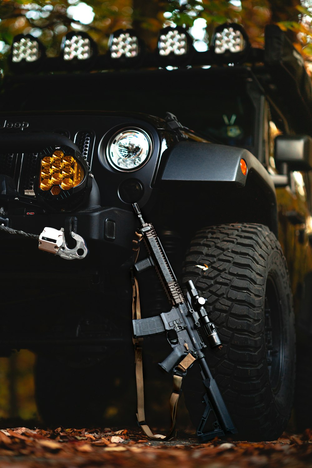 a black jeep with a gun on the front of it