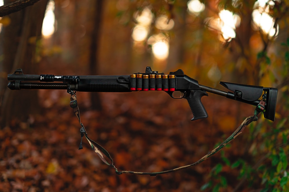 a rifle that is on a chain in the woods