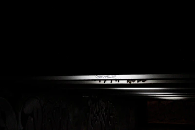 A gritty graffiti wall layered with vibrant street art under soft evening light.