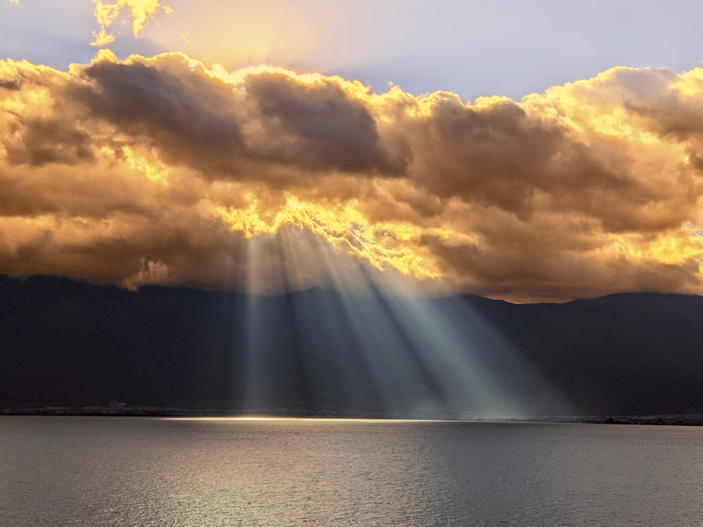 a large body of water under a cloudy sky