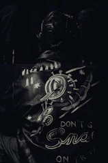 a black and white photo of a man wearing a leather jacket