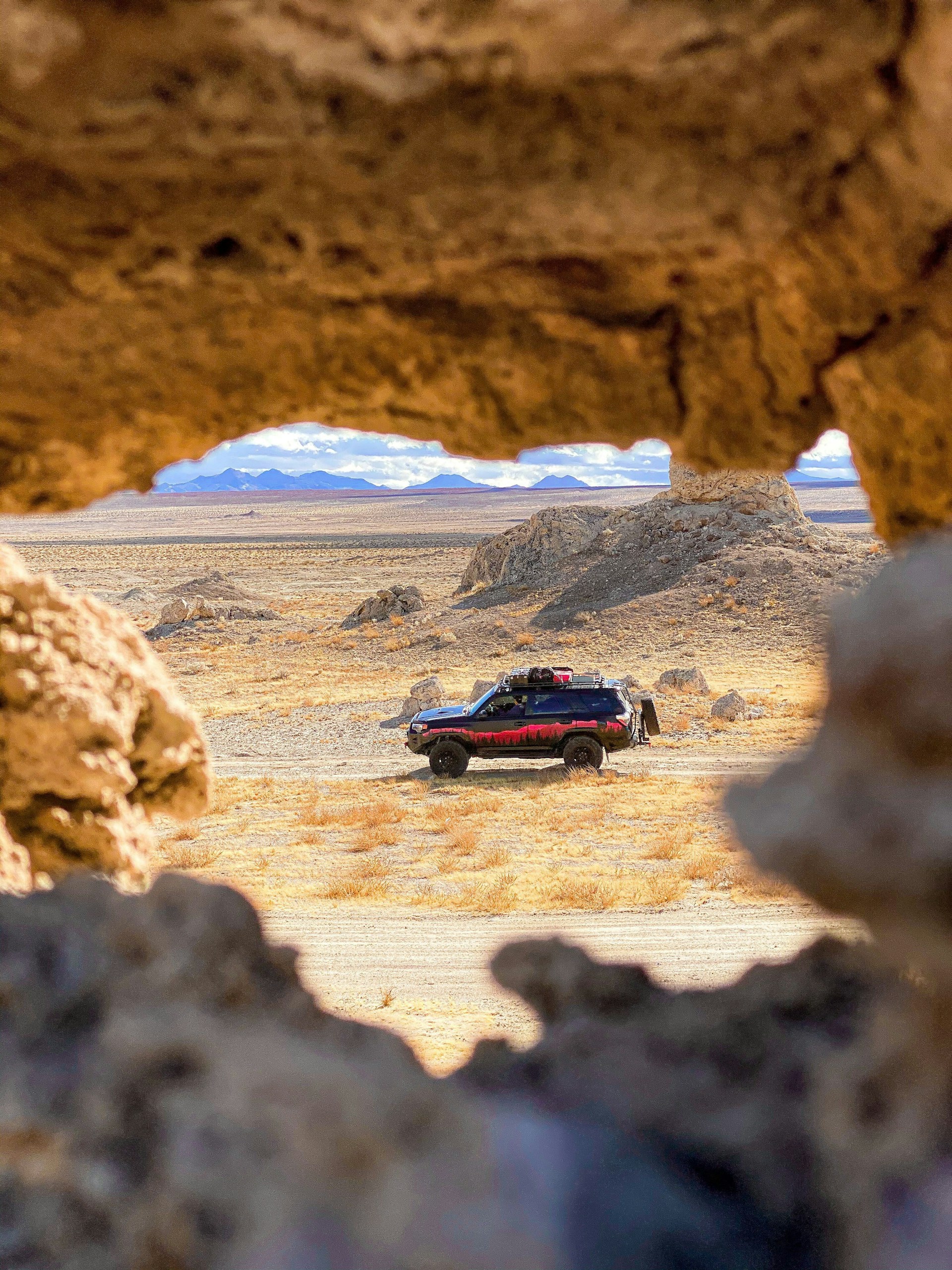 a car is parked in the middle of the desert