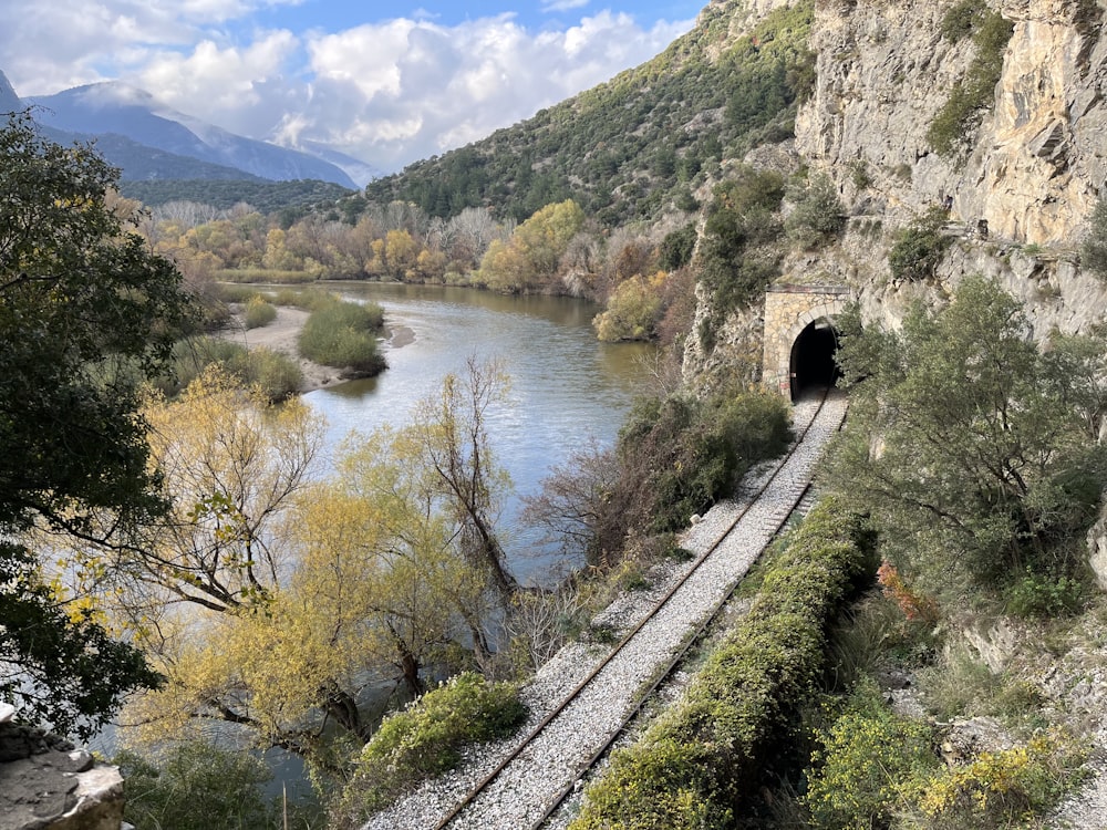 a train traveling through a tunnel next to a river