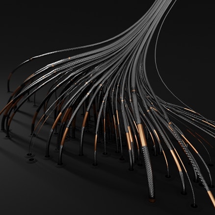 Numerous black cables or tubes with metallic and copper elements appear to be extending from a singular point, creating a fan-like spread. The cables have a textured spiral pattern, and the image has a dark, industrial aesthetic.