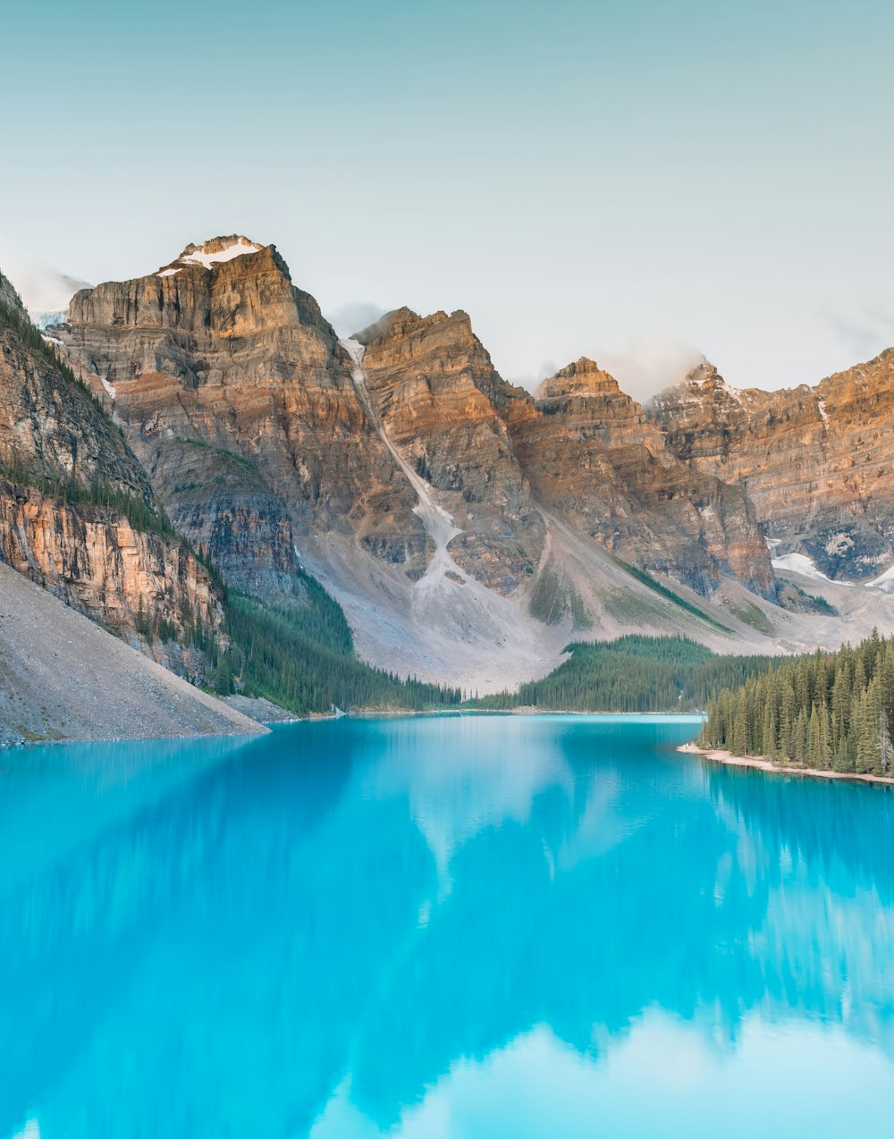 a blue lake surrounded by mountains and trees