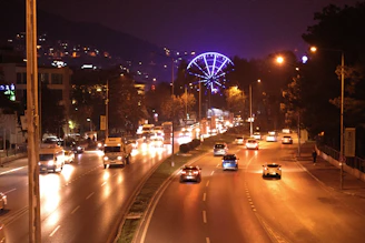 a city street filled with lots of traffic at night