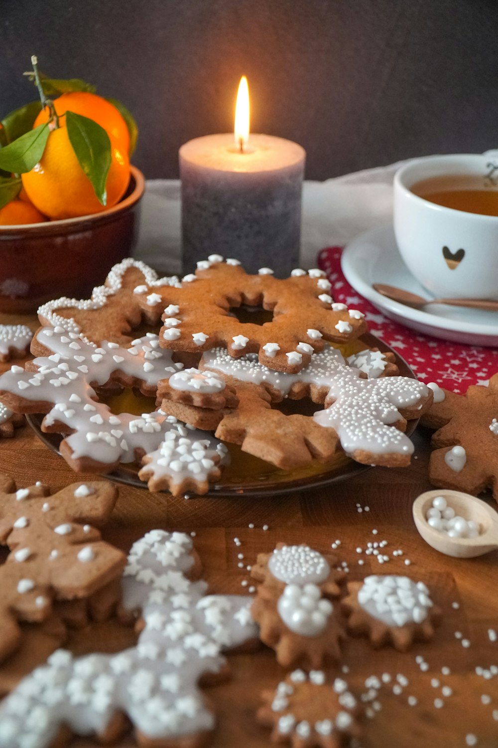 a wooden table topped with lots of cut out cookies