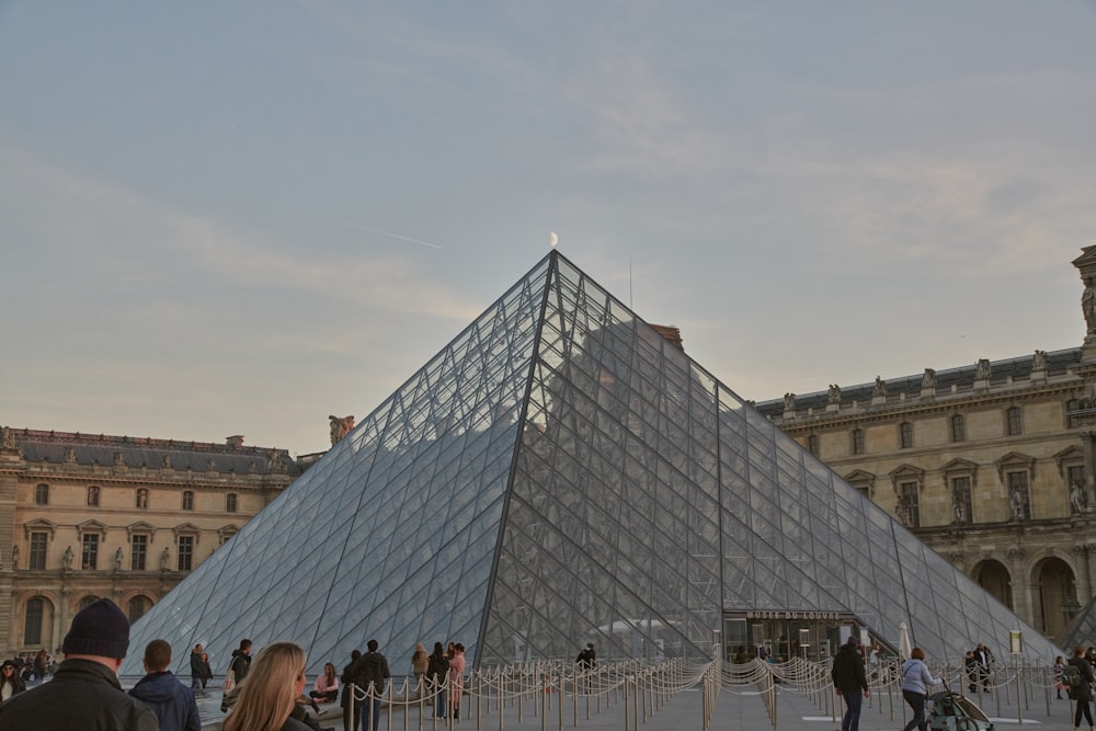 a large glass pyramid sitting in the middle of a courtyard