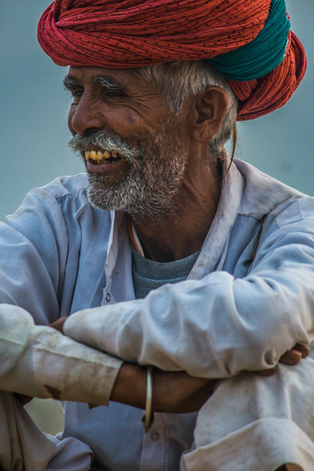 a man wearing a red and green turban