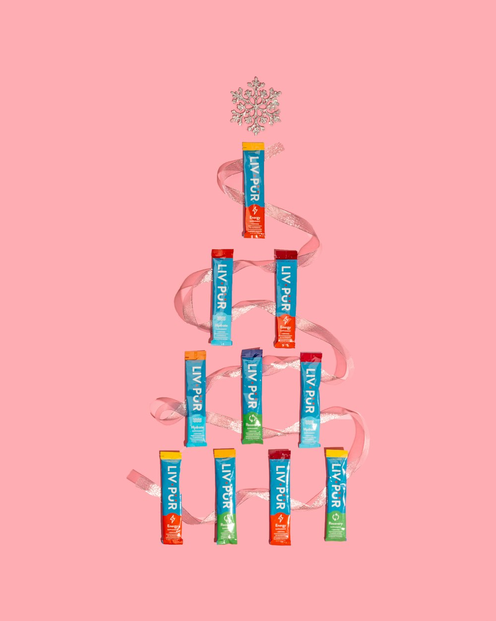 a christmas tree made out of candy bars on a pink background